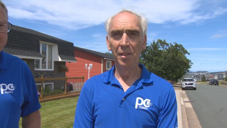 Man in blue collared shirt with PC logo.