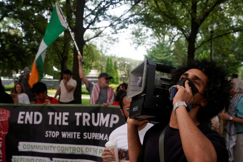 Demonstrators opposing Donald Trump's presidential candidacy are seen outside the Chicago-hosted convention of the U.S. National Association of Black Journalists on Wednesday.