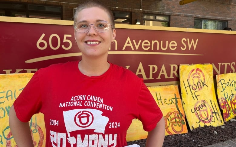 A person with a red t-shirt smiles for the camera.