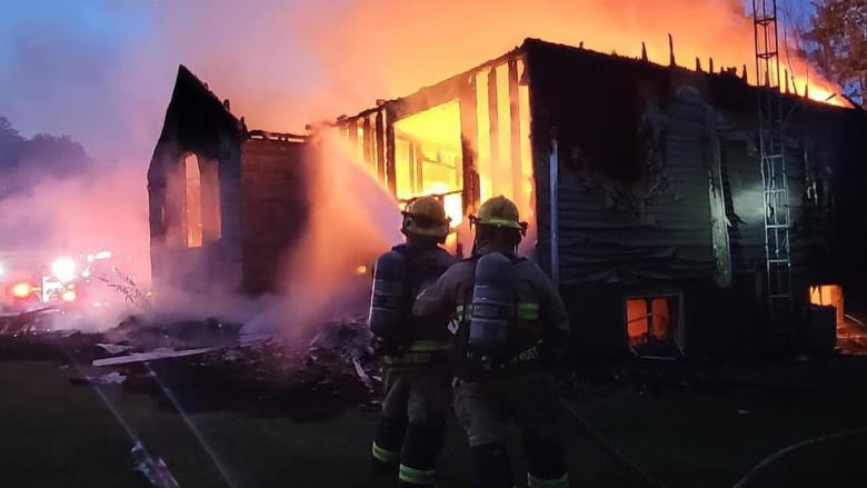 Firefighters fight a house fire.