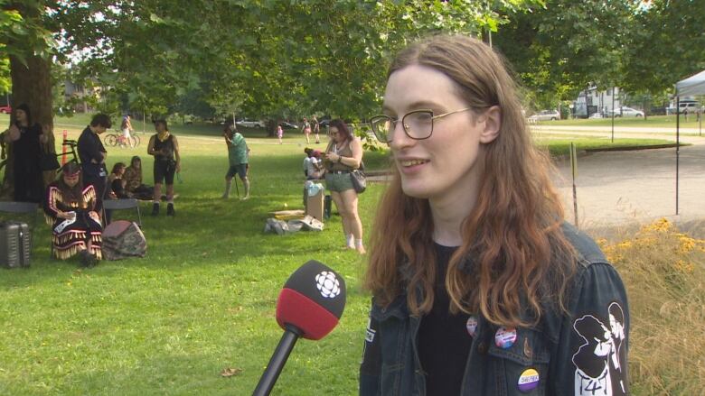 A person standing in front of a CBC microphone