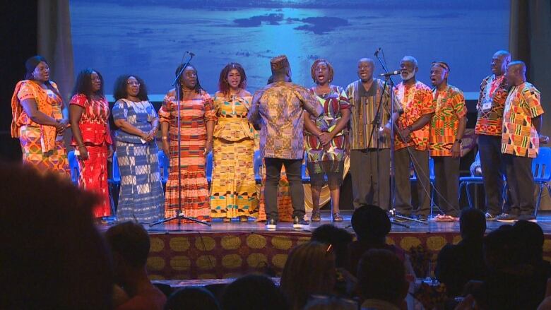 People sing on a stage. 