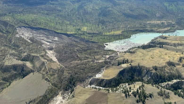 A bird's eye view of a landslide along a river.