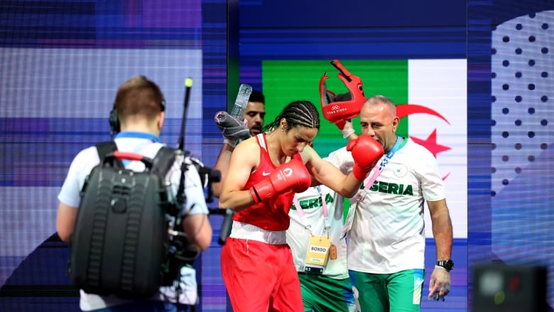 A female boxer prepares for a fight.