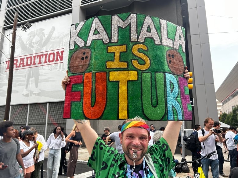 A man holds a sign