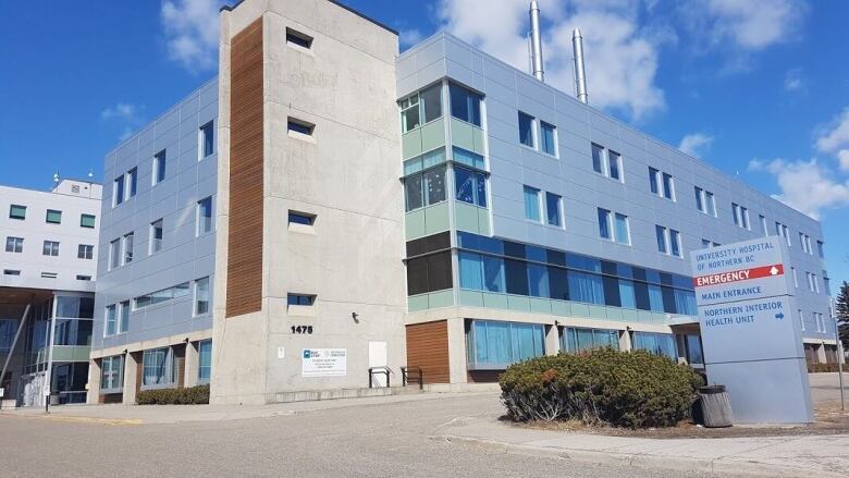 A large four-storey blue building.