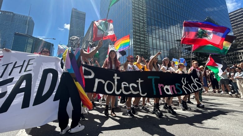 People hold a sign saying 