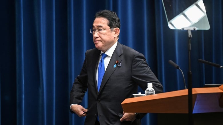 Japanese Prime Minister Fumio Kishida arrives at a press conference in Tokyo on Wednesday. Kishida confirmed he will not seek re-election as leader of Japan's governing party.