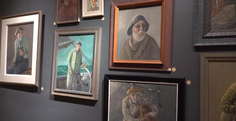 Several paintings of Maritime fishermen are on display in a collage on an art gallery wall.