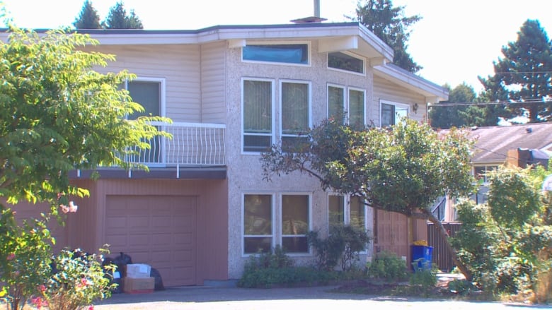 A large duplex with many windows and an attached garage.