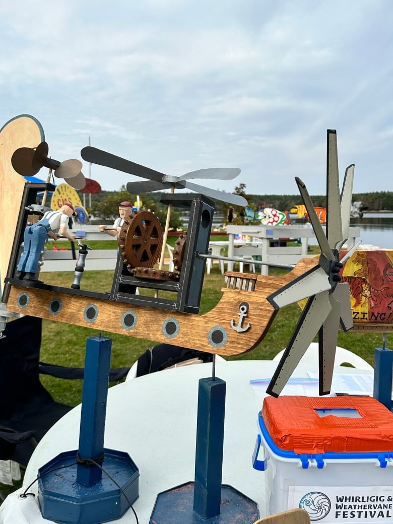 Whirligig with two propellers, gears and a small figure