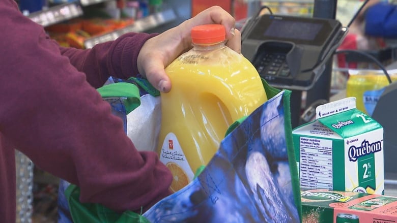 a customer bagging groceries