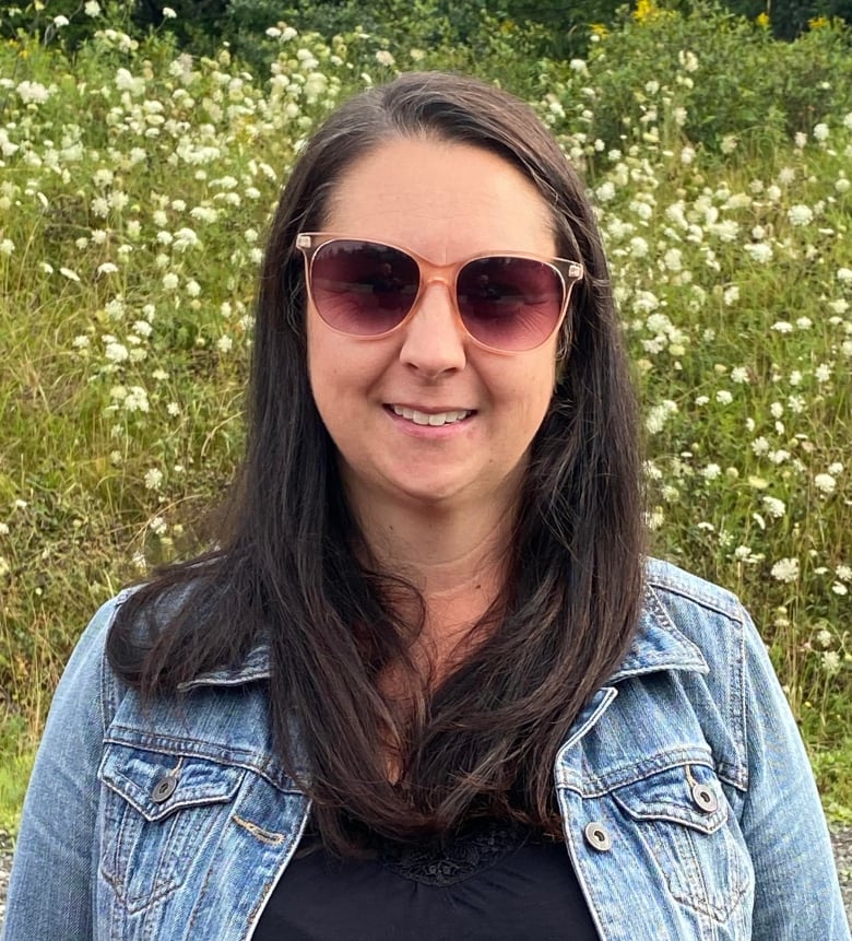 Woman in sunglasses smiling. 