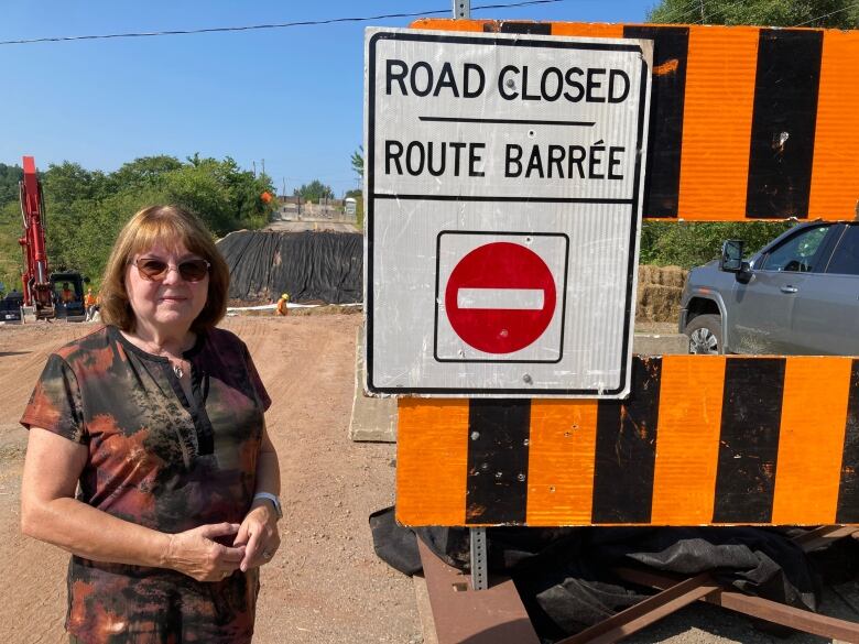 A woman by a sign