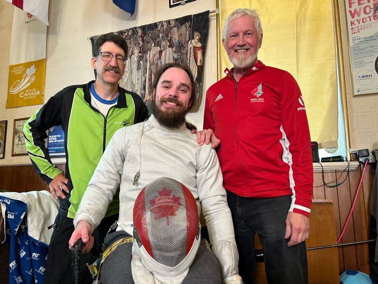 Ryan Rousell (middle) alongside Saskatchewans Provincial coach John Brunning (left) and Head Coach of the Asquith Garde Fencing Club Doug Brecht (right).