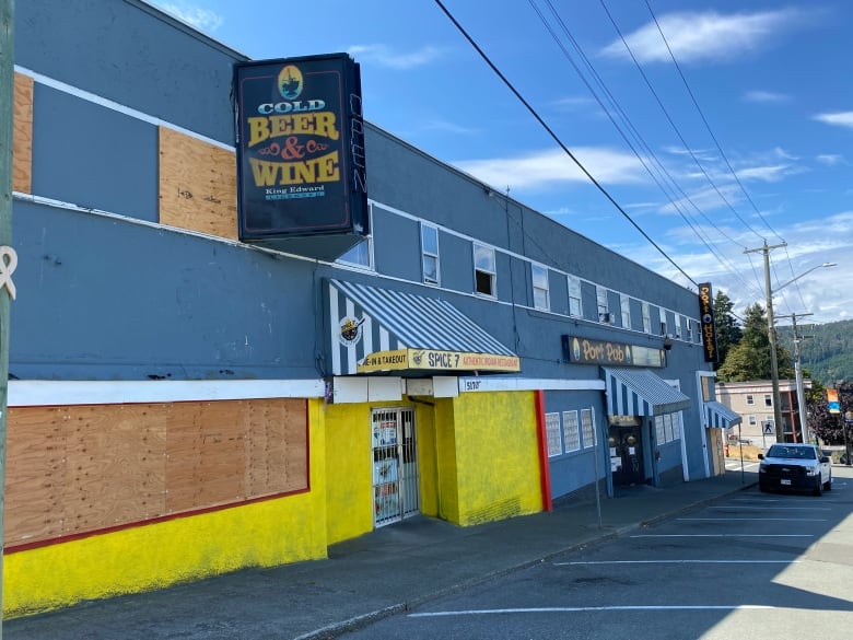 A long, low blue building with a sign that says Port Pub above the entrance.