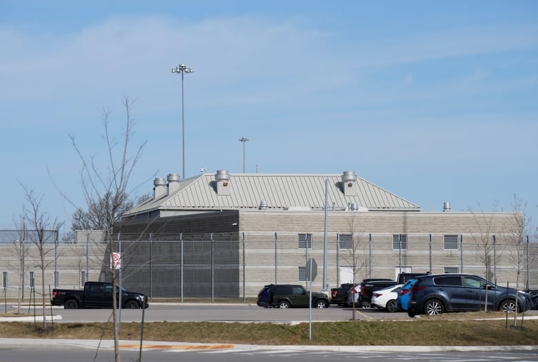 A jail is surrounded by wire fencing