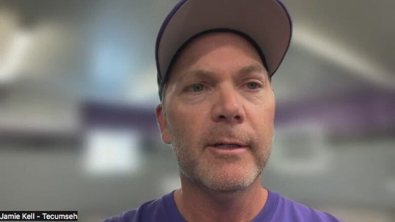 A man in a baseball cap talks via Zoom.