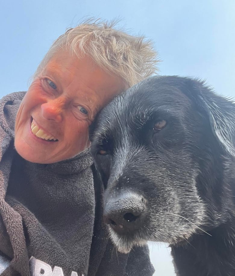 Woman with a dog outdoors.