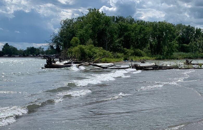 Water level view of the sand beach barrier that's eroded between Rondeau Bay and Lake Erie.