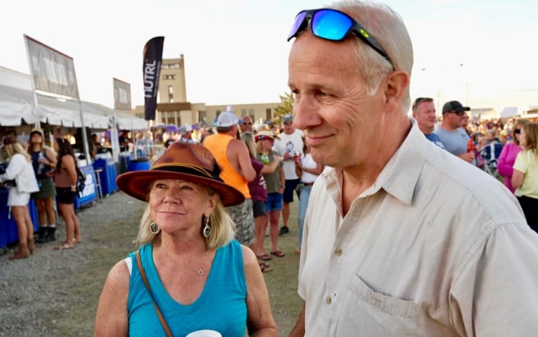 A man and woman at a festival.