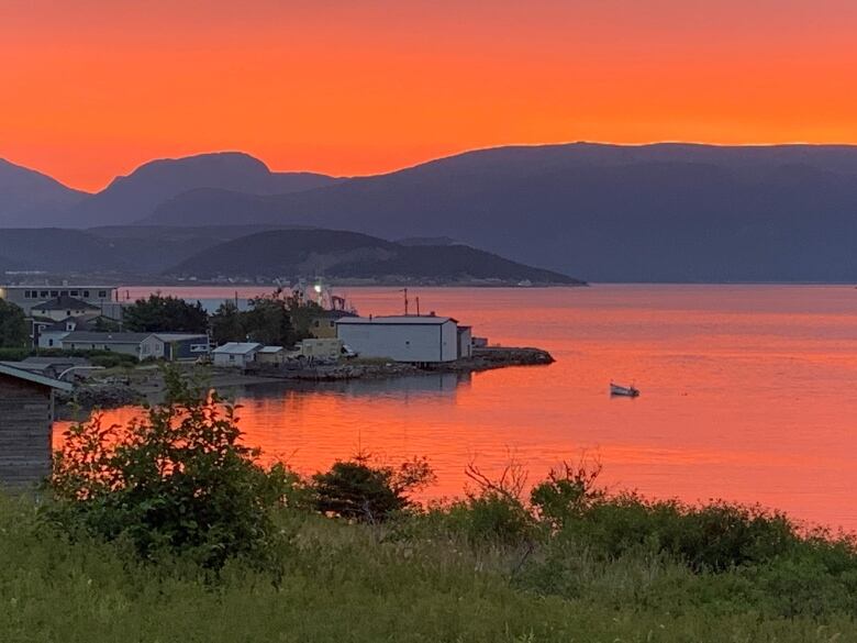 A red sky over a small harbour.