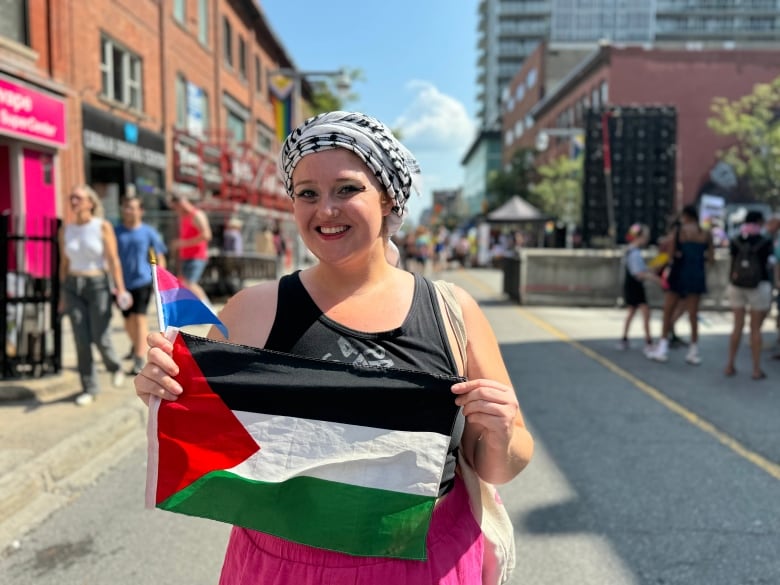 A woman holds a Palestine flag at Capital Pride Aug. 25, 2024.