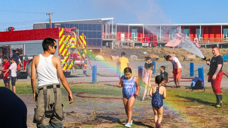 kids running through a hose