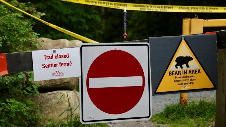 Trail closed off as indicated by yellow tape and red sign. 