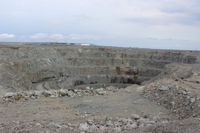 A big pit in rock ground with ridges running along the perimeter. 