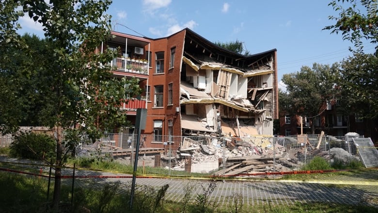 The exposed interior and debris of an apartment building.