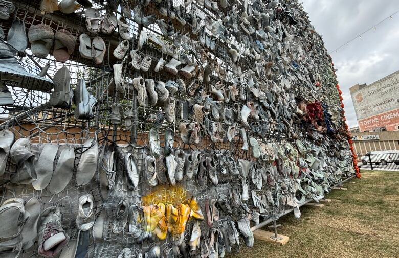 Shoes arranged on an tall outdoor display.