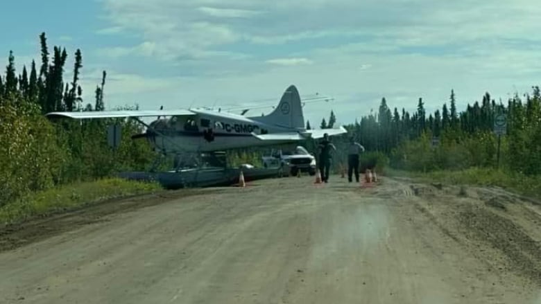 A floatplane on a dirt road 