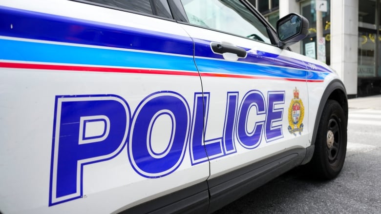 A white police vehicle with blue lettering.