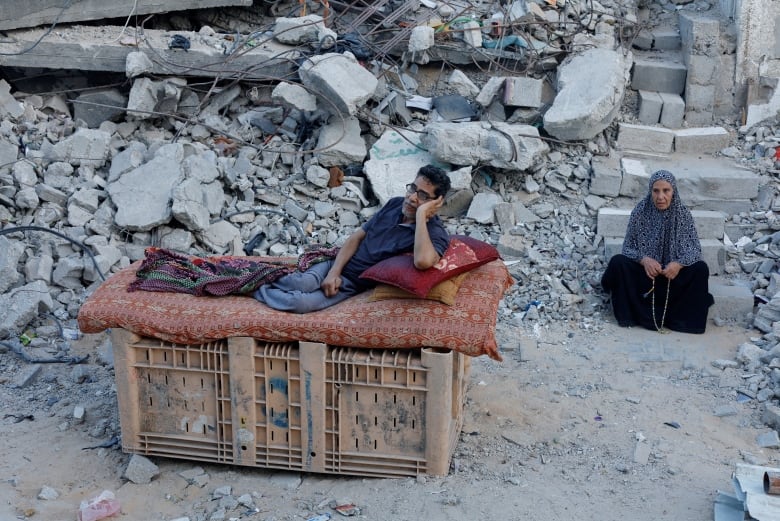 A Palestinian sits amidst the rubble of buildings destroyed after an Israeli strike, amid the ongoing conflict between Israel and Hamas, in Khan Younis, in the southern Gaza Strip September 1, 2024. 