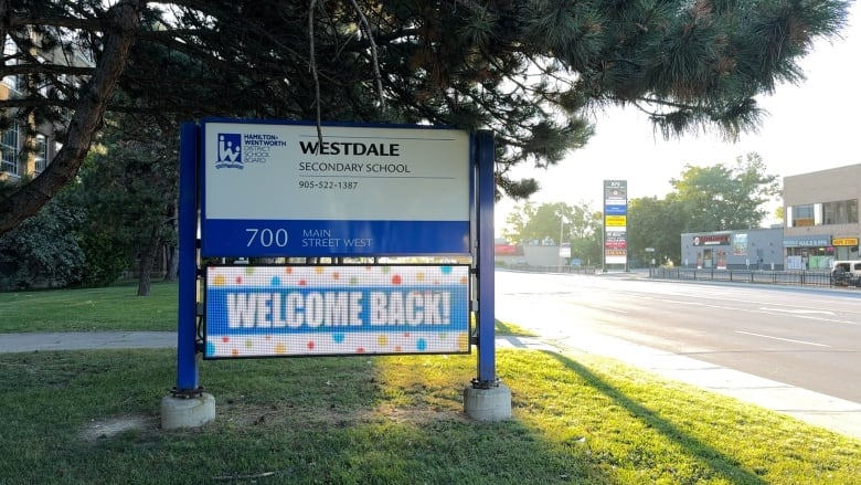 A school sign for Westdale Secondary School with a digital sign under that reads 