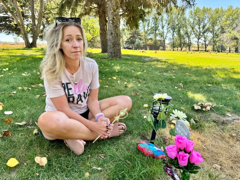 A woman sitting with flowers in her hand. 