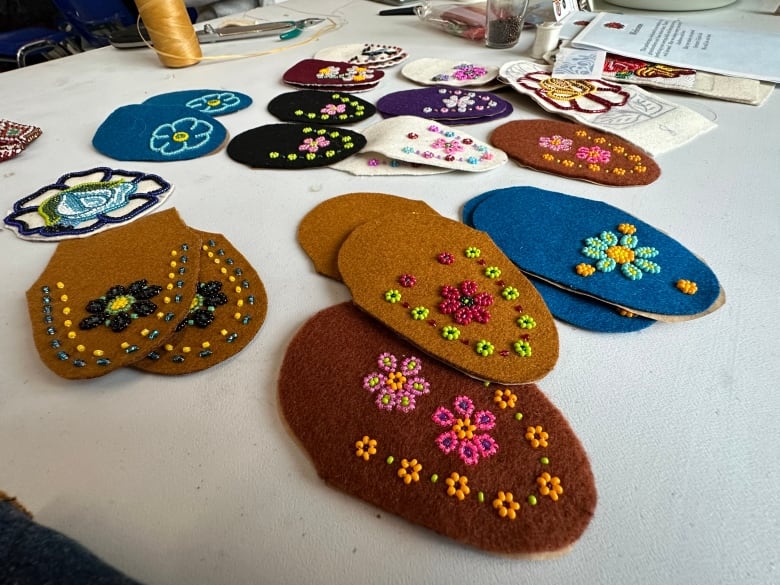 Many pieces of felt beaded with different designs.