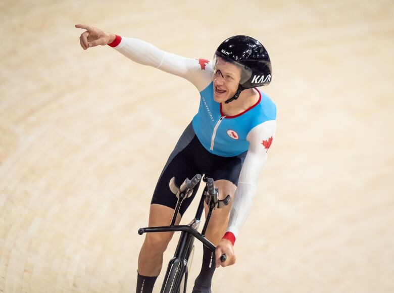 A biker points to the crowd.