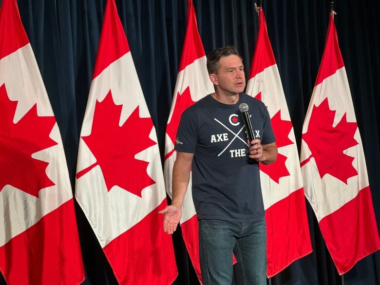 Pierre Poilievre in a t-shirt that says axe the tax