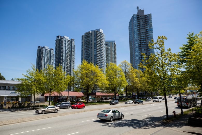 A series of tall apartment buildings are seen on a sunny day.