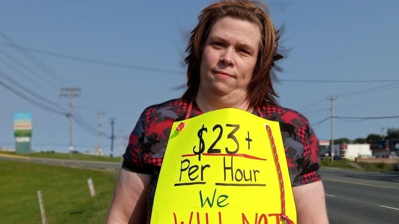 A woman with a sign