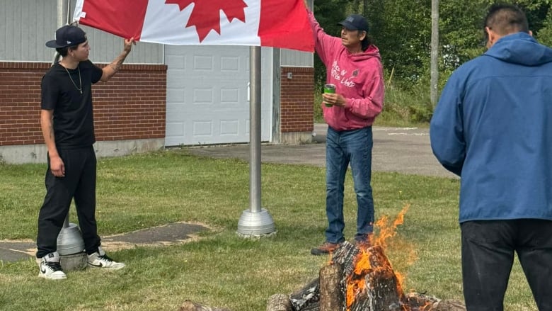 men standing with upside down flag