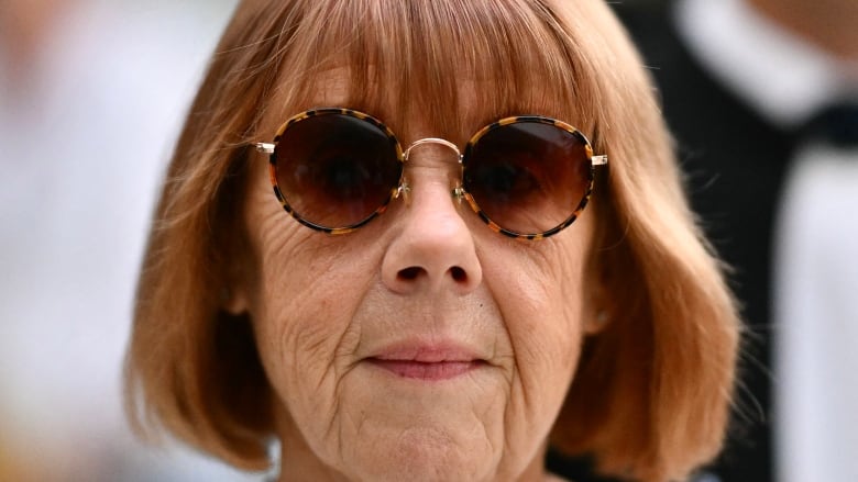 A close-up of a woman in sunglasses