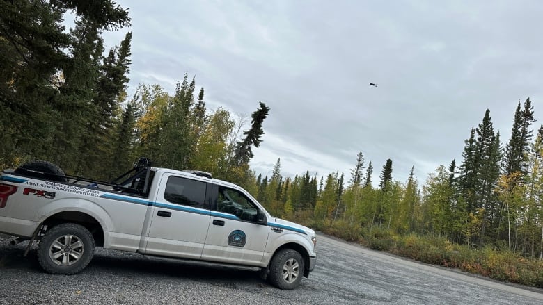 A drone flies above a truck.