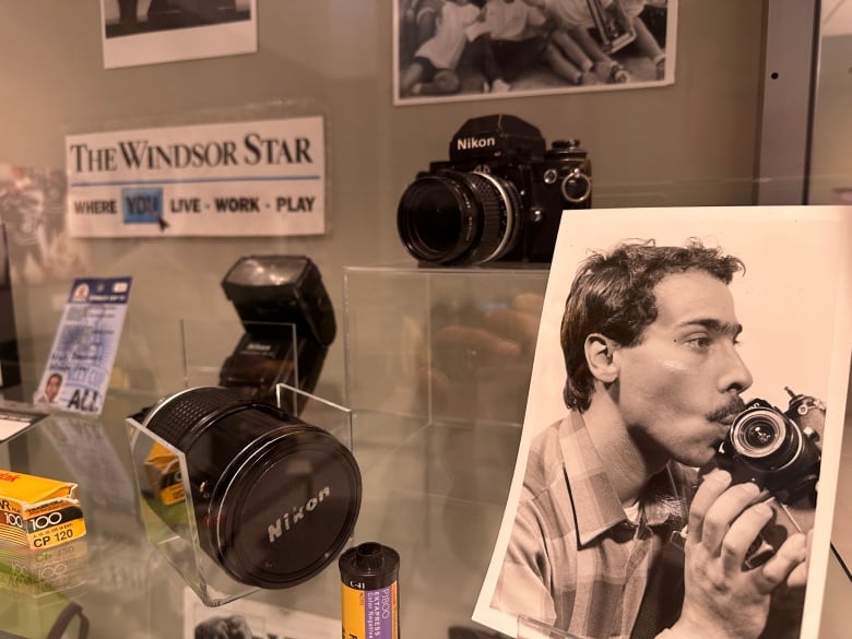 A photographer's memorabilia in a glass case.