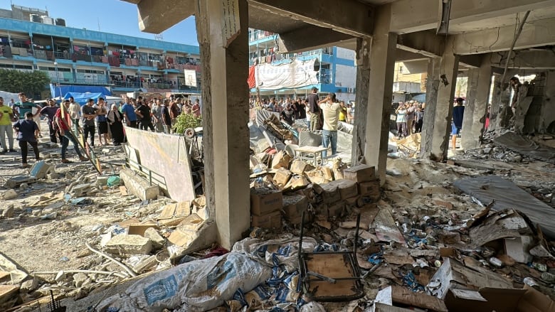 People inspect the remnants of a school hit by an airstrike.