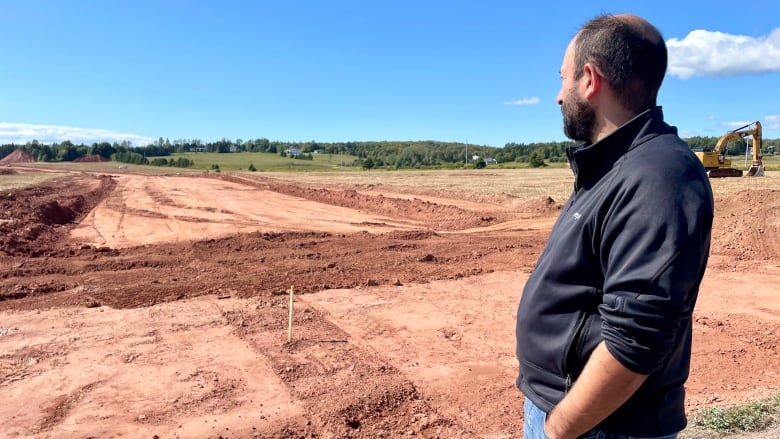 Dan Sud, who lives near the new subdivision in Rice Point, looks out at some of the initial site work that's happened.  