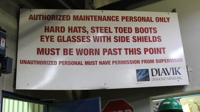 A sign with safety messaging inside a building.