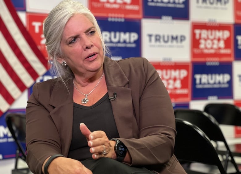 Woman in front of Trump signs